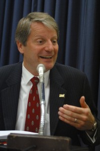 John making a point during a debate, 2009