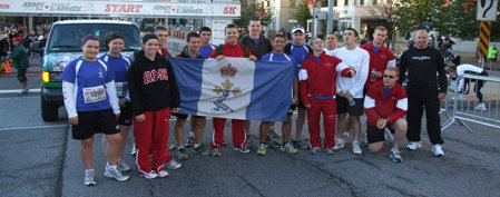 1.	The RMC Saint-Jean team holding their flag before the run. / L’équipe du CMR Saint-Jean tenant fièrement son drapeau avant le début de la course. 