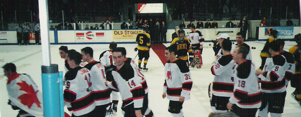 Paul Whalen with Cdn Flag draped around him following 3-2 O.T. win over West Point in 2002.