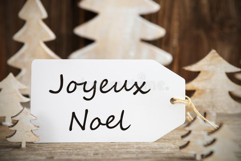 christmas-tree-label-joyeux-noel-means-merry-french-text-white-wooden-as-decoration-brown-background-163063184