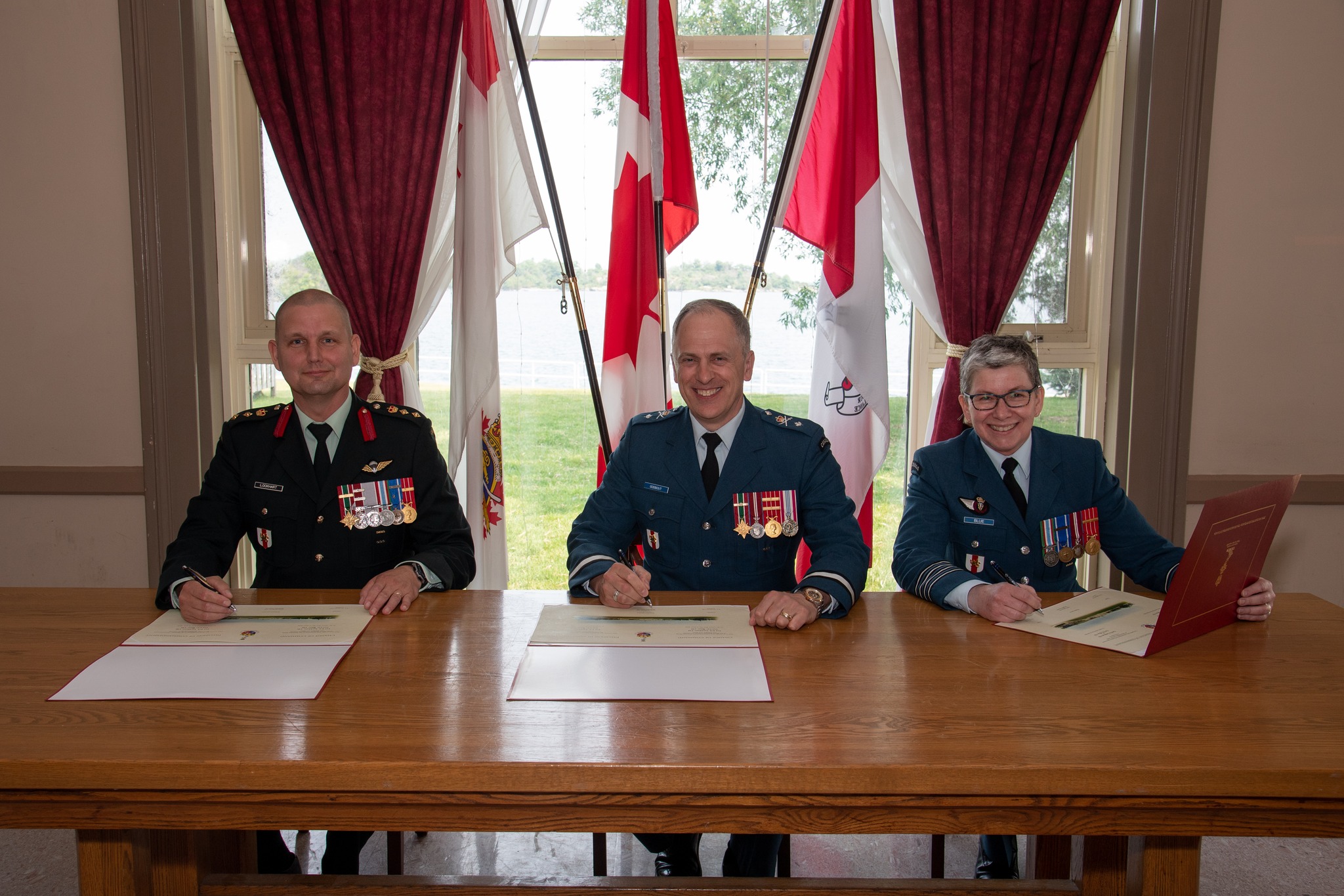 Director of Cadets Change of Command ceremony held at the Royal Military College of Canada (RMC) to say farewell to Colonel Paul Lockhart and to welcome Colonel Cathy Blue. In this photo, Colonel Paul Lockhart, out-going Director of Cadets (left); Brigadier-General Pascal Godbout, Commandant of the RMC (center) and Colonel Cathy Blue, in-coming Director of Cadets (right) sign the Change of Command forms. Senior Staff Mess, Kingston, ON on June 21, 2023.

Image by: Sailor First Class Lisa Sheppard, Imagery T