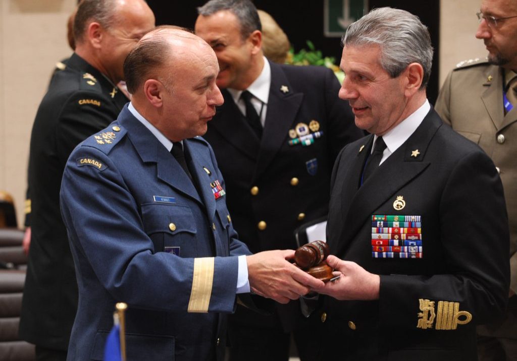 Outgoing Chairman of the NATO Military Committee General Ray Henault hands over the gavel to the new Chairman of the NATO Military Committee Admiral Giampaolo di Paola
