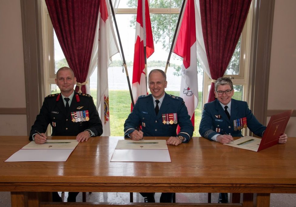 Director of Cadets Change of Command ceremony held at the Royal Military College of Canada (RMC) to say farewell to Colonel Paul Lockhart and to welcome Colonel Cathy Blue. In this photo, Colonel Paul Lockhart, out-going Director of Cadets (left); Brigadier-General Pascal Godbout, Commandant of the RMC (center) and Colonel Cathy Blue, in-coming Director of Cadets (right) sign the Change of Command forms. Senior Staff Mess, Kingston, ON on June 21, 2023.

Image by: Sailor First Class Lisa Sheppard, Imagery T